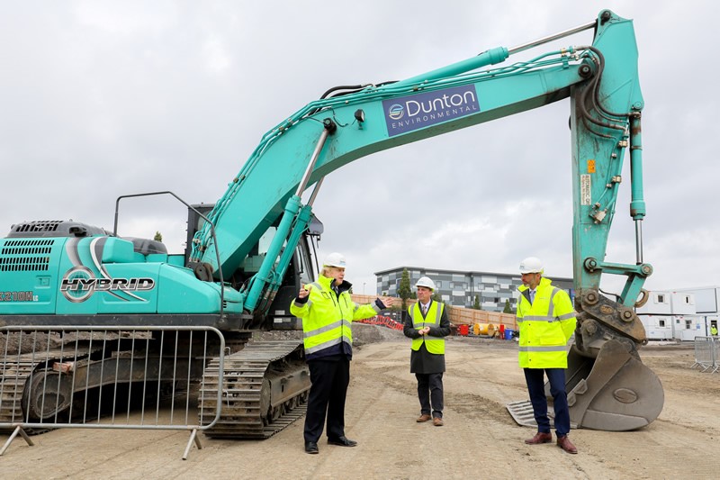 PM Boris Johnson with workers by Dunton Environmental digger