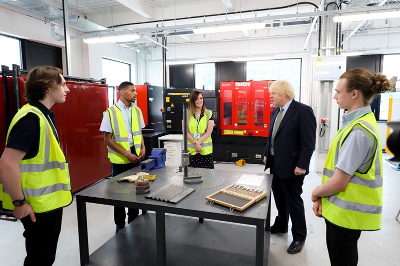 PM Boris Johnson and students within factory